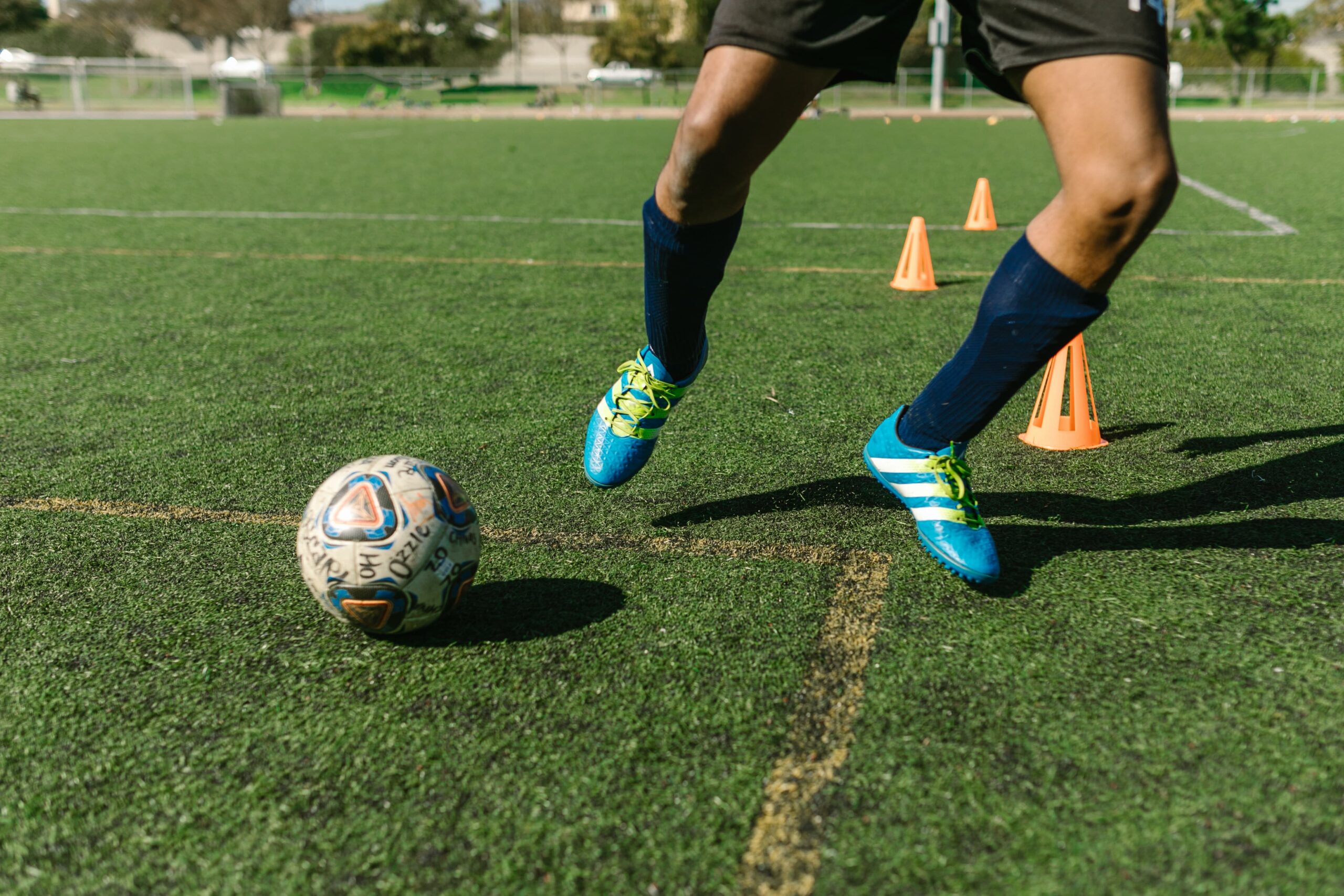 Man in football cleats doing football drills